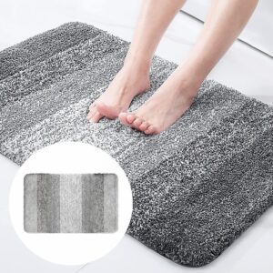 Shaggy microfiber bath mat, striped gray gradient, soft absorbent rug for bathroom floor.