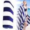 Blue and white striped cotton beach towel, soft and absorbent, perfect for poolside or seaside use.