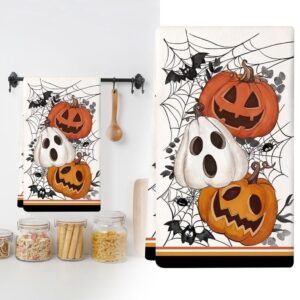 White cotton Halloween kitchen towel with orange jack-o'-lanterns, white ghost pumpkin, spiderwebs, and bats.