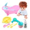 Plastic baby doll bath set: brown hair doll in robe, pink tub, yellow bowl, comb, spoon, fork, hairdryer, bottle.