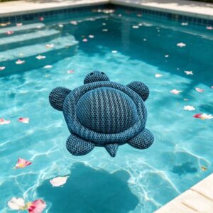 Blue mesh turtle-shaped pool cleaner floating in a swimming pool with flower petals.