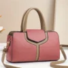 Women's faux leather handbag, pink and tan, with top handles and shoulder strap for daily use.