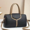 Black and tan textured faux leather handbag with top handles and shoulder strap, for everyday use.
