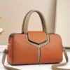 Brown & beige faux leather satchel handbag with top handles & shoulder strap, for everyday use.