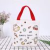 White canvas tote bag with red handles, "Rabbit Space" cartoon print, snap closure, for daily use.