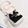 Black and white canvas crossbody bag with bunny ears, "Chong Ya!" text, and a plush bunny charm for casual use.