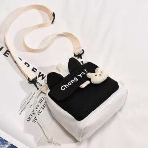 Black and white canvas crossbody bag with bunny ears, "Chong Ya!" text, and a plush bunny charm for casual use.