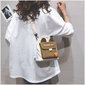 White canvas drawstring crossbody bag with brown flap, "Chong ya!" text, rabbit ears, and carrot charm.