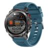 Rugged smartwatch with round black metal case, blue silicone strap, and digital display for fitness tracking.