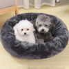 Round plush pet bed, dark grey, soft faux fur, for small dogs and cats to sleep comfortably.