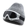 Gray knitted beanie hat with white-framed, dark-lensed goggles attached, for winter sports or fashion.
