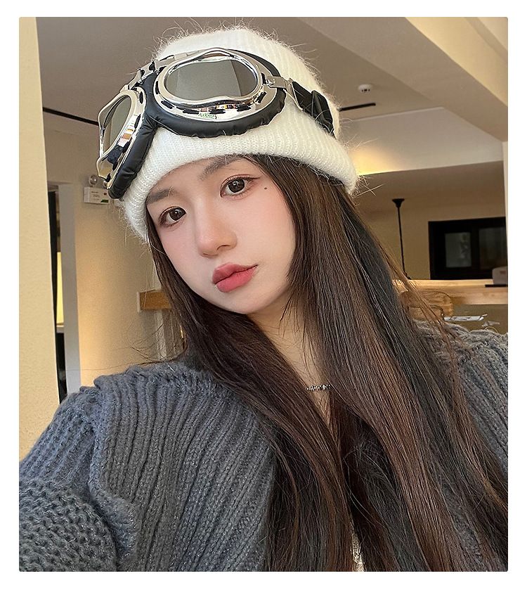 Black Rabbit Hair Aviator Hat With Detachable Sunglasses – Sumo Deals White Knitted Beanie With Attached Silver Aviator Goggles, Worn By A Woman For A Stylish, Retro Look.