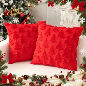 Pair of red plush Christmas tree textured throw pillows for festive holiday home decor.