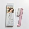 Pink plastic liquid scalp comb with clear dropper for hair oil application.