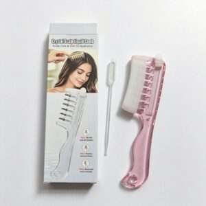 Pink plastic liquid scalp comb with clear dropper for hair oil application.