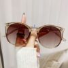 Round frame sunglasses, clear brown plastic, gradient brown lenses, for women's fashion and sun protection.