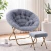 Gray faux fur saucer chair with tufted cushion and matching ottoman, gold metal folding frame, for cozy seating.