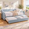 Light blue velvet daybed with tufted back and roll-out trundle bed, perfect for guest rooms or living spaces.